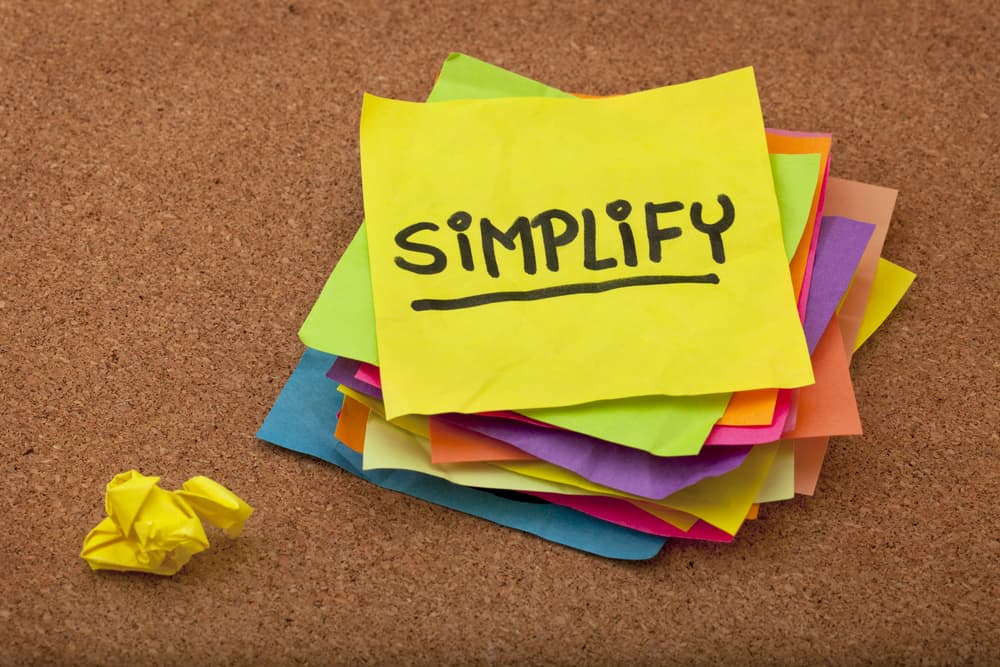 Pragmatic or get organized concept, simplify reminder - a stack of colorful sticky notes on cork bulletin board